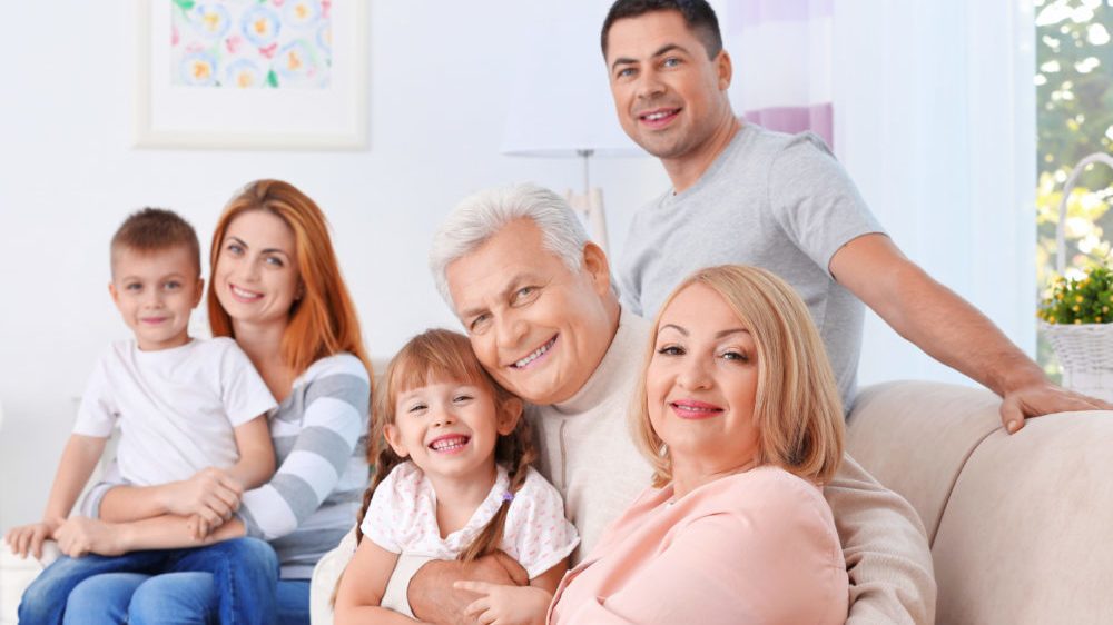 Big happy multiple generations of family sitting on couch.