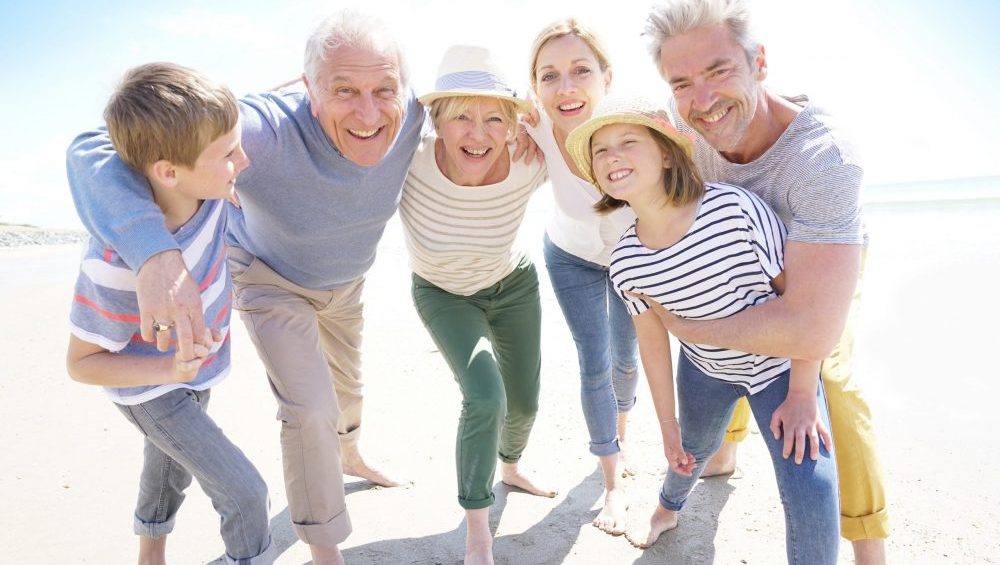 Portrait of happy multi-generational family having fun on the beach.