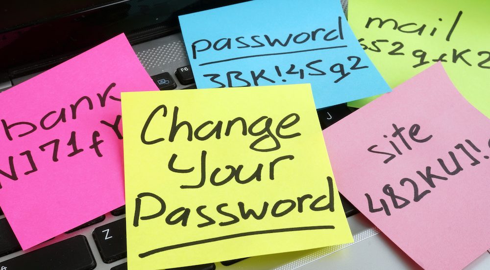 Laptop with Post-It notes to remind user to create strong online passwords.