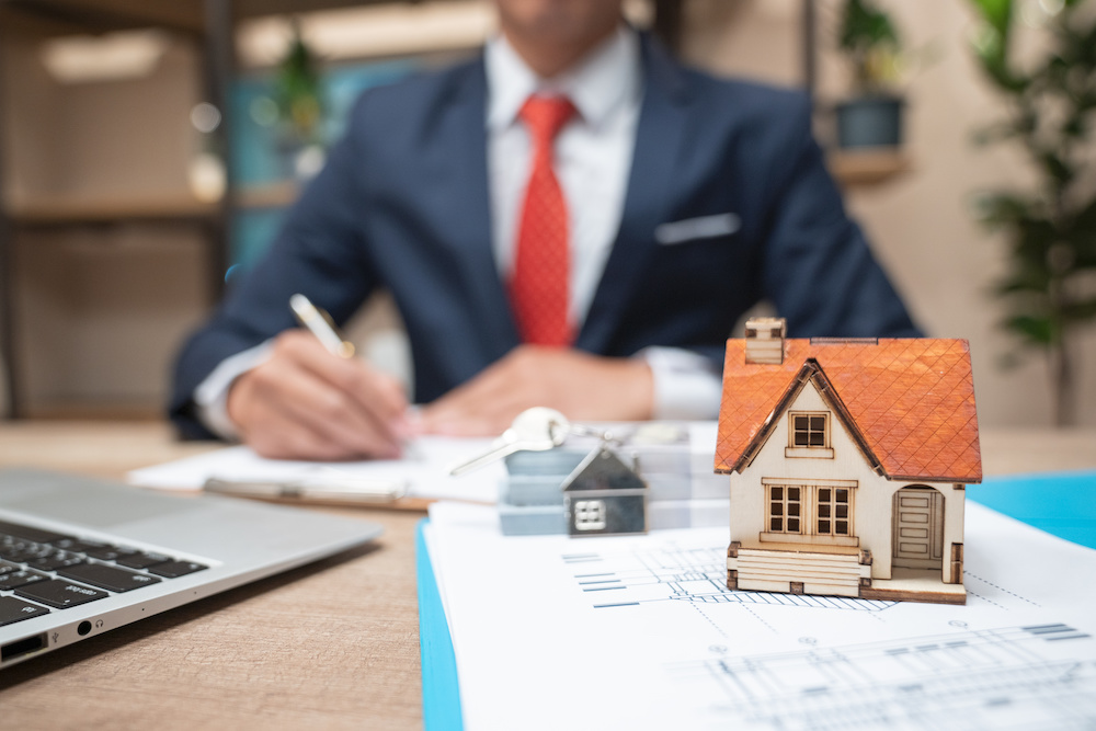 Selling a home to a business man in a suit and tie as an investment property.