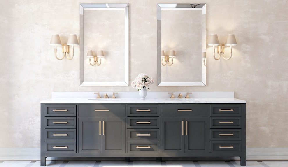 Classic luxury bathroom with marble floor, brass fixtures and dark vanity cabinets.