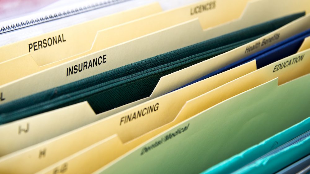 Close up of personal financial life files in expanding pocket folders