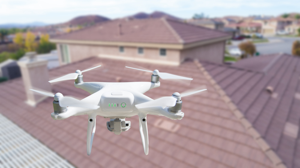 Drone In the air over a house Inspecting the roof.