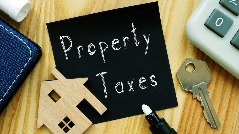 Terms related to property tax appraisal are shown on a blackboard.