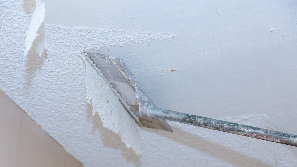 Home ceiling drywall demolition of popcorn ceiling.