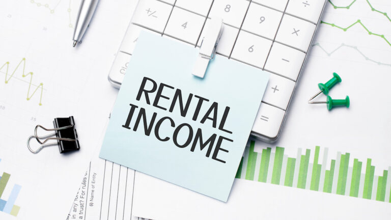 The text on the photo is rental income. Written words on a paper notebook to present the vacation rental concept.
